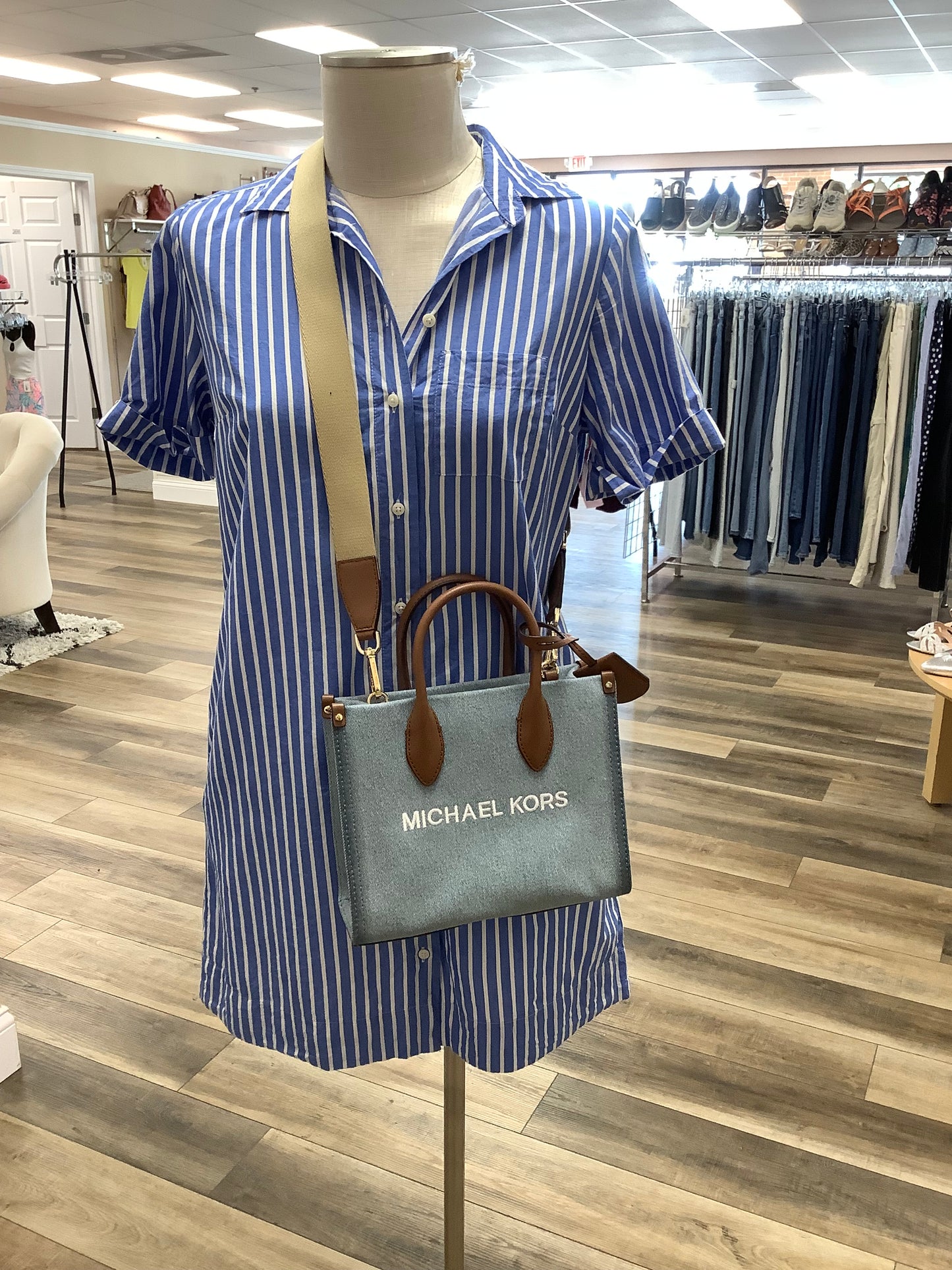 Michael Kors Mirella Small Denim Crossbody Bag in a blue washed denim material with brown leather trim