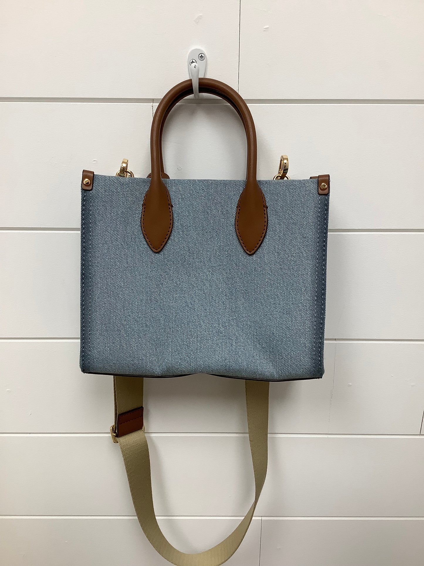Michael Kors Mirella Small Denim Crossbody Bag in a blue washed denim material with brown leather trim